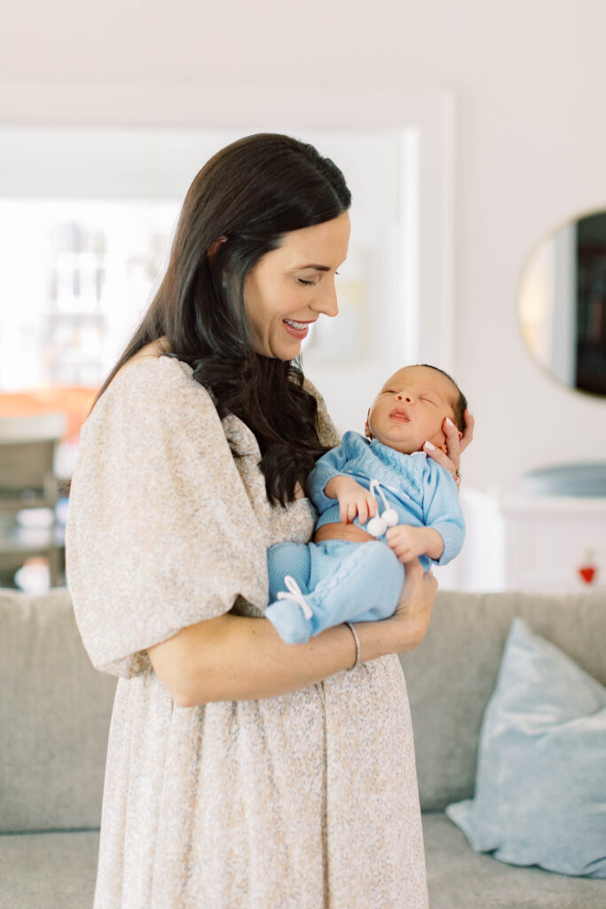 mom holding newborn son in her home