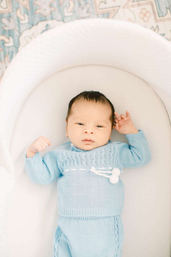 newborn son in bassinet