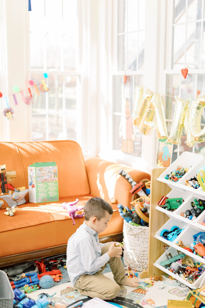 boy playing with toys in playroom that is colorful 