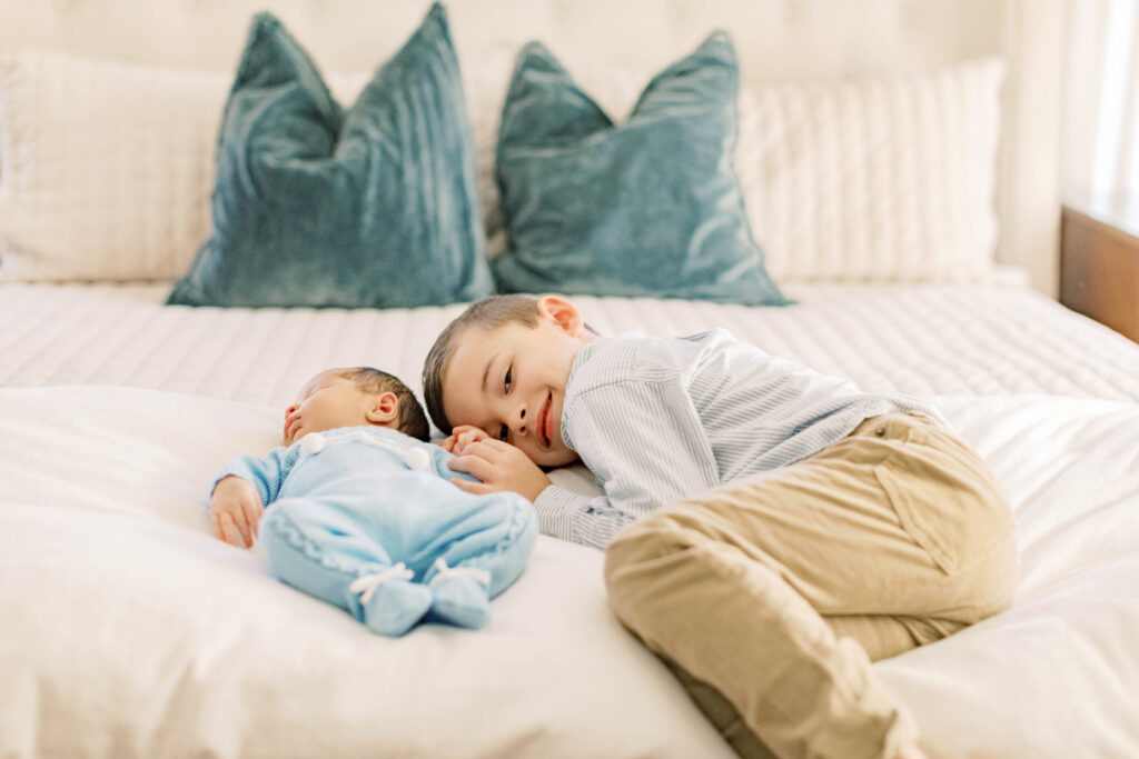 brother on bed with his baby 