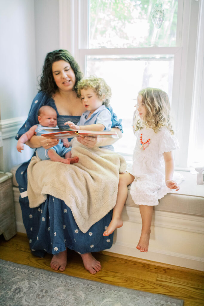 mom reading a book to her kids