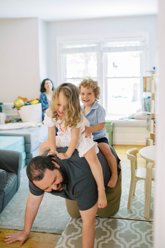 dad giving toddlers piggy back ride