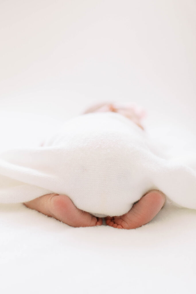 newborn on tummy with booty up and feet out 