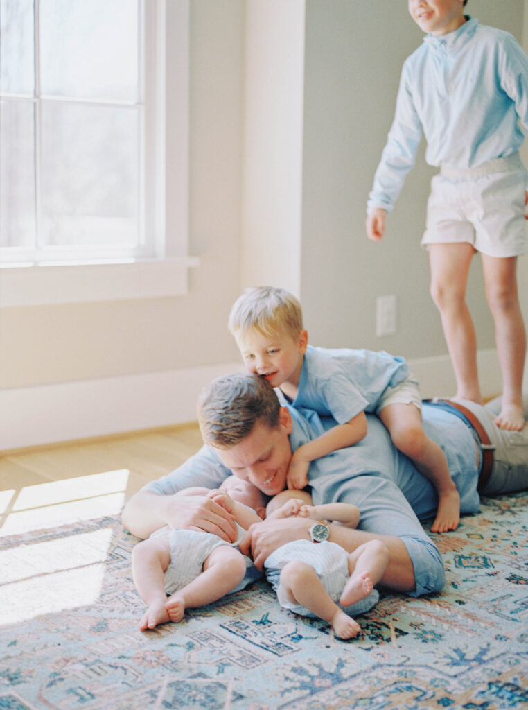 dad on floor with kids playing 