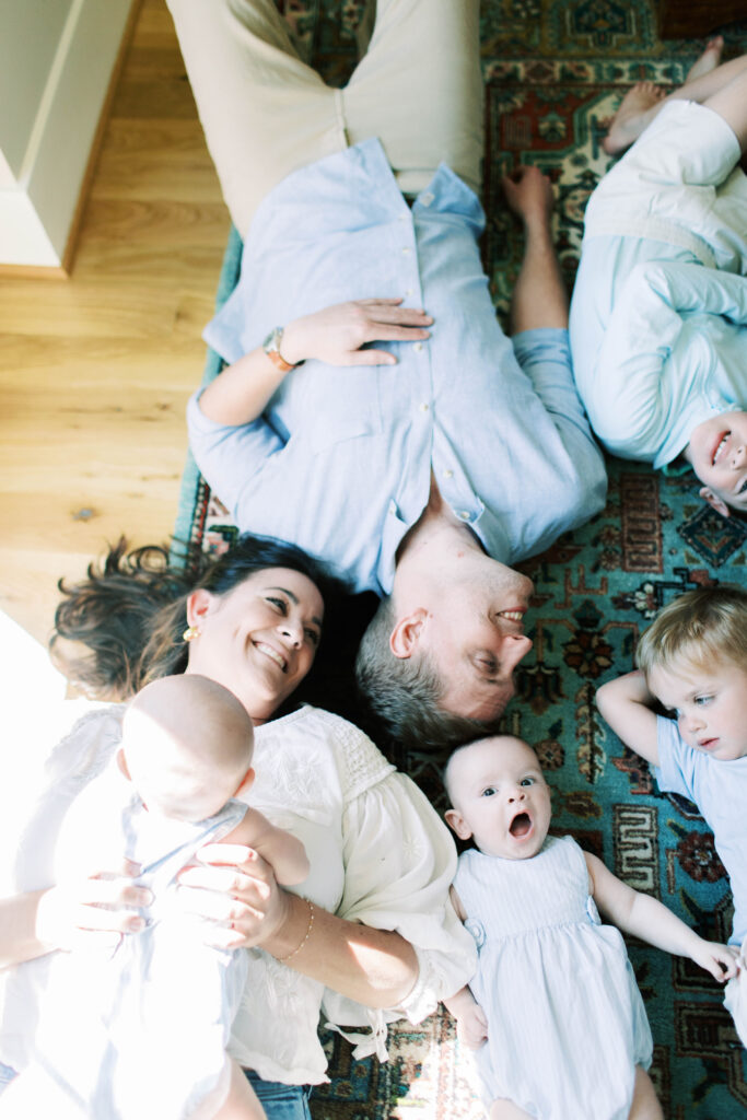 family laying on ground together 