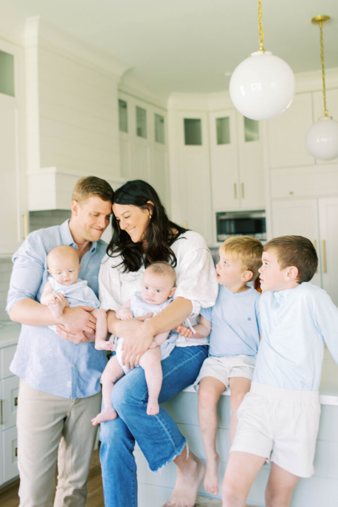 family hanging out in kitchen together 