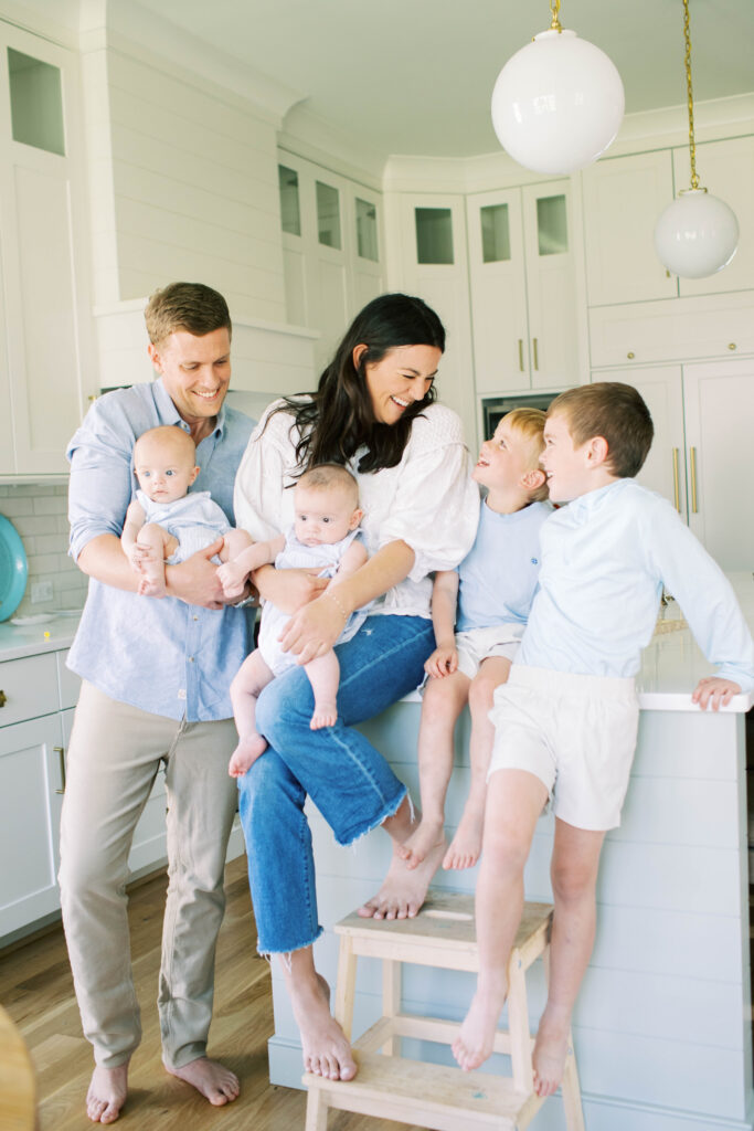 family hanging out in kitchen together 