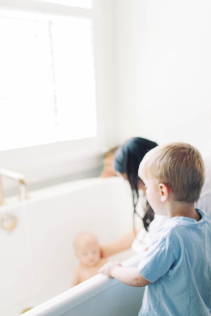 mom giving baby a bath 