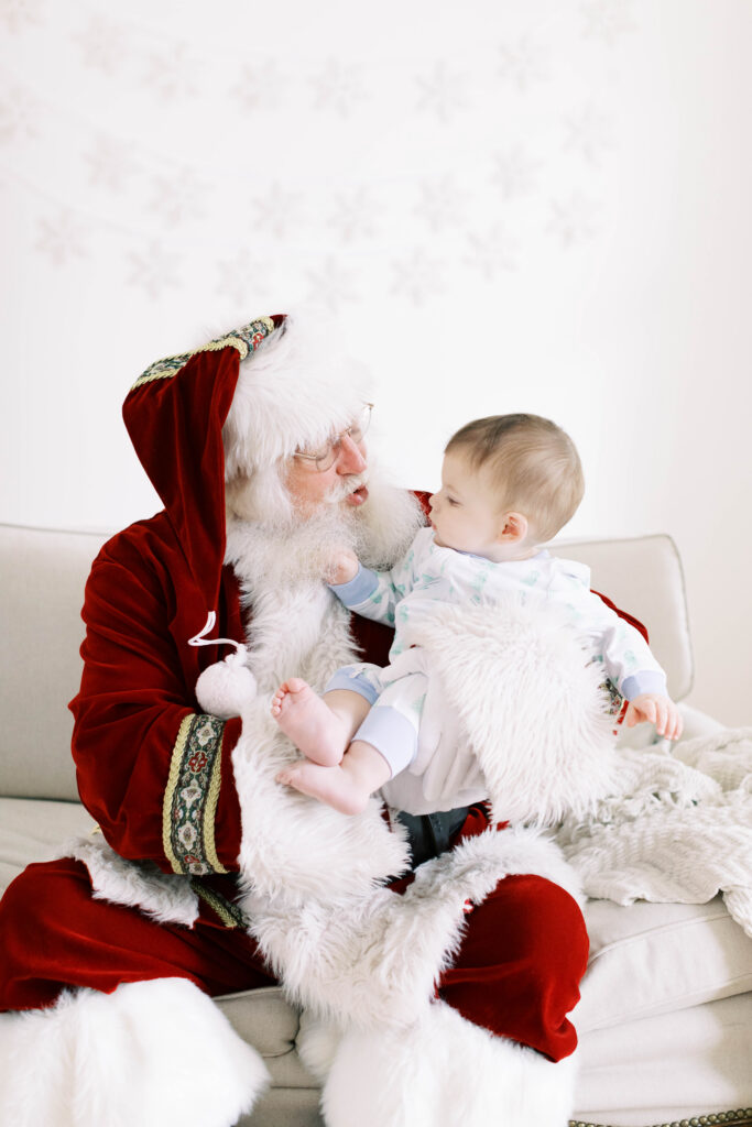 baby boy sitting on santas lap 