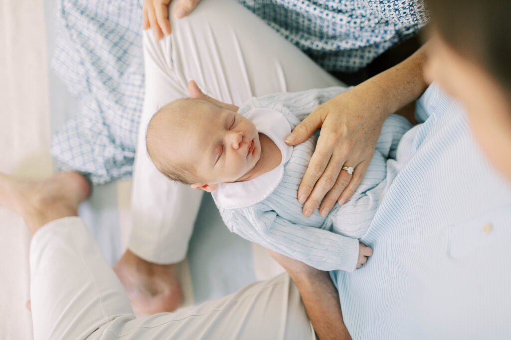 mom and dad holding newborn boy